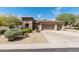 Charming single-story home boasting a three-car garage and desert landscaping at 30434 N Palo Brea Dr, Scottsdale, AZ 85266
