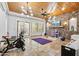 Bright flex room features an exercise bike and yoga mat, complemented by a wood ceiling and wall accents at 30434 N Palo Brea Dr, Scottsdale, AZ 85266