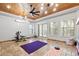 A flex room is fitted with an exercise bike, wood plank ceiling, and versatile space for hobbies and fitness at 30434 N Palo Brea Dr, Scottsdale, AZ 85266