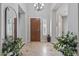 Elegant foyer featuring tile flooring, a wooden front door, and attractive decor at 30434 N Palo Brea Dr, Scottsdale, AZ 85266