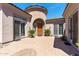 Inviting front entry with a beautiful paver patio, double doors, and desert landscaping at 30434 N Palo Brea Dr, Scottsdale, AZ 85266