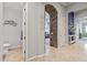 Hallway with gray walls leads to a powder room, living room, and other areas of the home at 30434 N Palo Brea Dr, Scottsdale, AZ 85266