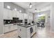 A bright kitchen showcases white cabinets, modern appliances, granite countertops, and an island, open to the dining area at 30434 N Palo Brea Dr, Scottsdale, AZ 85266