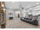 Open concept living area with stone fireplace, neutral tones, and lots of natural light at 30434 N Palo Brea Dr, Scottsdale, AZ 85266