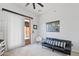 Minimalist living room with modern black sofa and natural light filtering through the door and white vertical blinds at 30434 N Palo Brea Dr, Scottsdale, AZ 85266