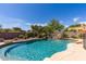 Resort-style pool area featuring rock waterfall features and lush tropical landscaping at 30434 N Palo Brea Dr, Scottsdale, AZ 85266