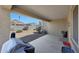 A covered patio with gravel landscaping, shrubbery, and perimeter fencing at 31006 W Weldon Ave, Buckeye, AZ 85396