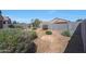 An expansive backyard with gravel landscaping, shrubbery, and perimeter fencing at 31006 W Weldon Ave, Buckeye, AZ 85396