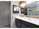 Bright bathroom with a double vanity, framed mirror, with a view of the glass-enclosed shower at 31006 W Weldon Ave, Buckeye, AZ 85396