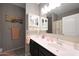 Neutral-toned bathroom features a single sink, white cabinets, and shower with a fun, ocean-themed shower curtain at 31006 W Weldon Ave, Buckeye, AZ 85396