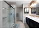 Bright bathroom featuring a double vanity, framed mirror, and glass enclosed marble shower at 31006 W Weldon Ave, Buckeye, AZ 85396