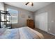 Comfortable bedroom with a window, carpeted floor, closet, shelving unit, and a dresser with several drawers at 31006 W Weldon Ave, Buckeye, AZ 85396