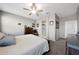 A bright bedroom with ceiling fan, windows, dresser, and connecting bathroom for convenience and privacy at 31006 W Weldon Ave, Buckeye, AZ 85396