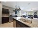 Spacious kitchen island with a double sink and views of the open floor plan at 31006 W Weldon Ave, Buckeye, AZ 85396