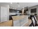 Modern kitchen with a spacious center island, stainless steel appliances, and granite countertops at 31006 W Weldon Ave, Buckeye, AZ 85396