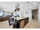 Open concept kitchen flows into the living area, featuring an island with a stainless steel dishwasher at 31006 W Weldon Ave, Buckeye, AZ 85396