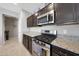 Well-equipped kitchen featuring stainless steel appliances, dark cabinetry, and granite countertops at 31006 W Weldon Ave, Buckeye, AZ 85396