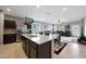 Modern kitchen with stainless steel appliances, granite countertops, and view of the living room at 31006 W Weldon Ave, Buckeye, AZ 85396