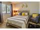 Cozy bedroom with a queen-size bed, natural light, and stylish décor at 3511 E Baseline Rd # 1104, Phoenix, AZ 85042