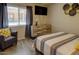 Well-decorated bedroom, featuring a media center and comfortable chair at 3511 E Baseline Rd # 1104, Phoenix, AZ 85042