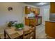 Eat-in kitchen area featuring wood cabinets, granite countertops, and stainless steel appliances at 3511 E Baseline Rd # 1104, Phoenix, AZ 85042