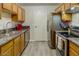 Charming kitchen with wood cabinets, stainless steel appliances, and stone countertops at 3511 E Baseline Rd # 1104, Phoenix, AZ 85042