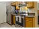 Well-lit kitchen featuring stainless steel appliances and granite countertops at 3511 E Baseline Rd # 1104, Phoenix, AZ 85042