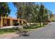 Street view of homes with manicured landscaping and mature trees at 3511 E Baseline Rd # 1104, Phoenix, AZ 85042