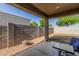 Comfortable covered back patio featuring a fire pit and views of the fenced backyard at 36203 N Urika Dr, San Tan Valley, AZ 85140