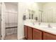 Bright bathroom with double sink vanity and a shower featuring a decorative curtain at 36203 N Urika Dr, San Tan Valley, AZ 85140