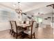 Cozy dining area adjacent to the living room, featuring a stylish chandelier and plenty of natural light at 36203 N Urika Dr, San Tan Valley, AZ 85140