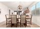 Bright dining room features a stylish light fixture and seating for six, perfect for Gathering meals at 36203 N Urika Dr, San Tan Valley, AZ 85140