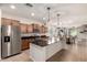 Spacious kitchen with stainless steel appliances, center island, and an adjacent dining area at 36203 N Urika Dr, San Tan Valley, AZ 85140