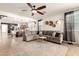 Inviting living room with open floor plan, neutral tones, and tile flooring throughout at 36203 N Urika Dr, San Tan Valley, AZ 85140