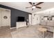 Comfortable living room with a large sectional sofa, decorative wall art, and an open layout to the dining area at 36203 N Urika Dr, San Tan Valley, AZ 85140