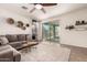 Bright living room with neutral tones, a comfortable sectional sofa, and sliding glass doors to the backyard at 36203 N Urika Dr, San Tan Valley, AZ 85140
