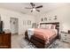 Stylishly decorated main bedroom with plush bedding, a ceiling fan, and comfortable furniture at 36203 N Urika Dr, San Tan Valley, AZ 85140