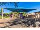 Community playground with play equipment shaded by large awning for Gathering enjoyment at 36203 N Urika Dr, San Tan Valley, AZ 85140