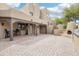Expansive backyard with a covered patio, outdoor fireplace, and brick paver flooring at 38953 N 57Th Pl, Cave Creek, AZ 85331