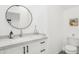 Modern bathroom with white vanity, round mirror, and contemporary fixtures at 38953 N 57Th Pl, Cave Creek, AZ 85331