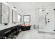 Luxurious bathroom with a black and copper tub, modern vanities, and a glass-enclosed shower at 38953 N 57Th Pl, Cave Creek, AZ 85331