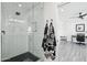 Bathroom featuring a glass-enclosed tiled shower, a decorative mirror, and a view into an office space at 38953 N 57Th Pl, Cave Creek, AZ 85331
