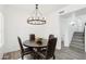 Elegant dining room featuring a round table, leather chairs, and a decorative chandelier at 38953 N 57Th Pl, Cave Creek, AZ 85331