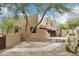 Stunning home exterior with desert landscaping, covered patio, outdoor kitchen, and beautiful architecture at 38953 N 57Th Pl, Cave Creek, AZ 85331