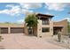 Eye-catching two-story home featuring a terracotta tile roof, multiple garages, and low-maintenance landscaping at 38953 N 57Th Pl, Cave Creek, AZ 85331