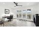 Bright home office with natural light, shutters, ceiling fan, and balcony access at 38953 N 57Th Pl, Cave Creek, AZ 85331