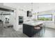 Modern kitchen with white cabinets, oversized island, marble counters, and desert views at 38953 N 57Th Pl, Cave Creek, AZ 85331