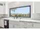 Modern kitchen featuring a farmhouse sink with a scenic outdoor view, white cabinetry, and marble countertops at 38953 N 57Th Pl, Cave Creek, AZ 85331