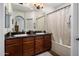 Bathroom features a double vanity, dark countertops, and a shower with a curtain at 3935 E Rough Rider Rd # 1252, Phoenix, AZ 85050