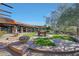 Exterior view of the clubhouse with lush landscaping, patio, and an outdoor fountain at 3935 E Rough Rider Rd # 1252, Phoenix, AZ 85050